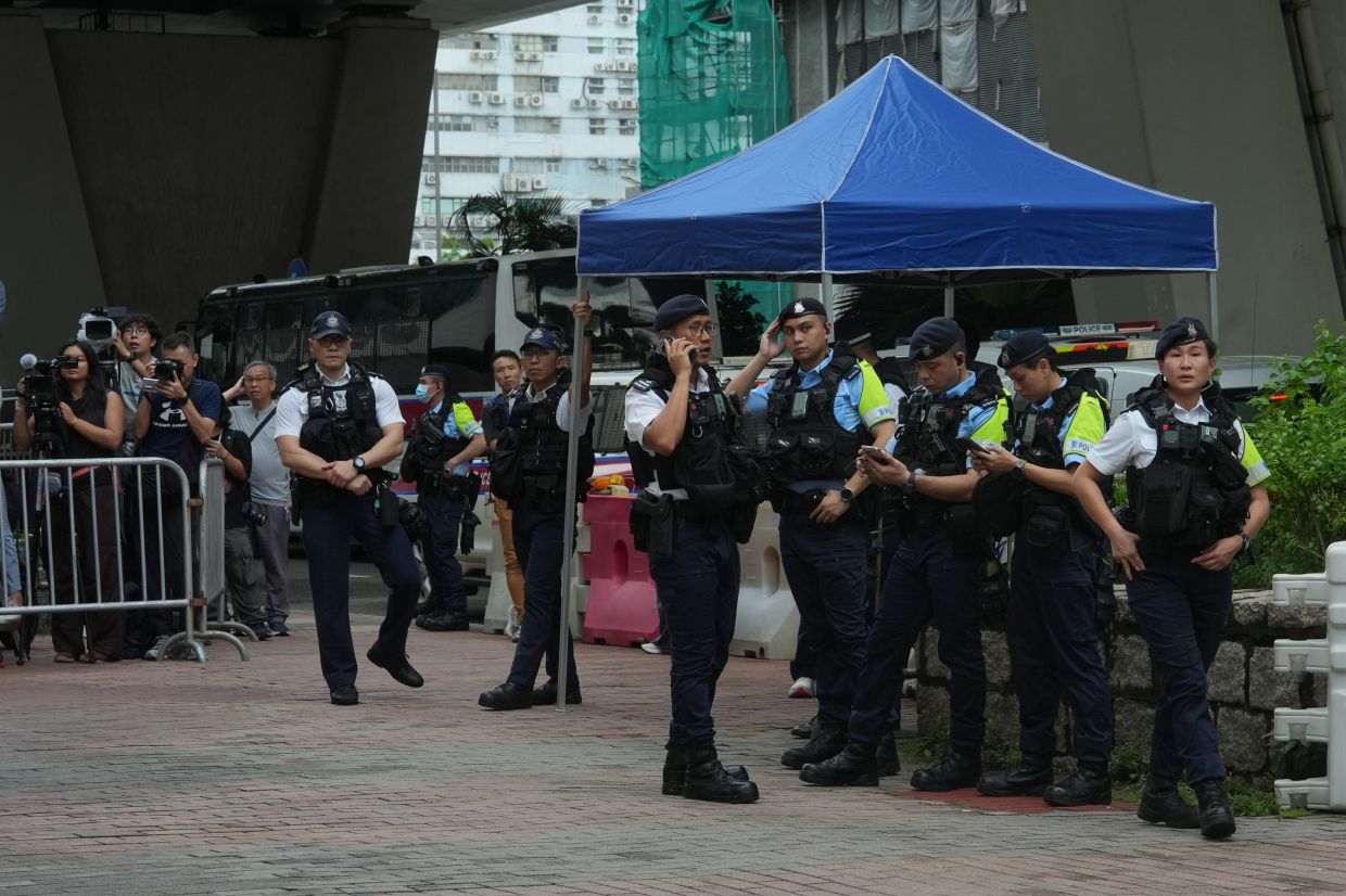Hong Kong woman detained over T-shirt message as courts tighten sedition rules