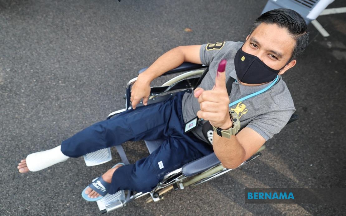 Determined To Serve: Injured Johor Cop Votes Despite Wheelchair Confinement